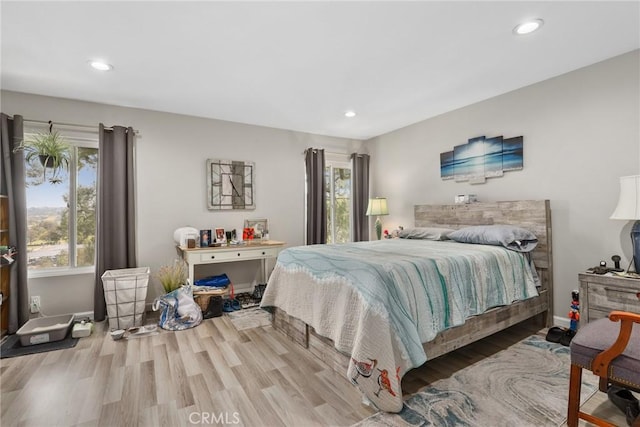 bedroom featuring baseboards, recessed lighting, and wood finished floors