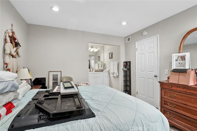 bedroom featuring an inviting chandelier, visible vents, recessed lighting, and ensuite bath