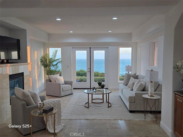 412 Arenoso Ln Unit 102, San Clemente, CA 92672 - living area with a tile fireplace, a water view, baseboards, and recessed lighting