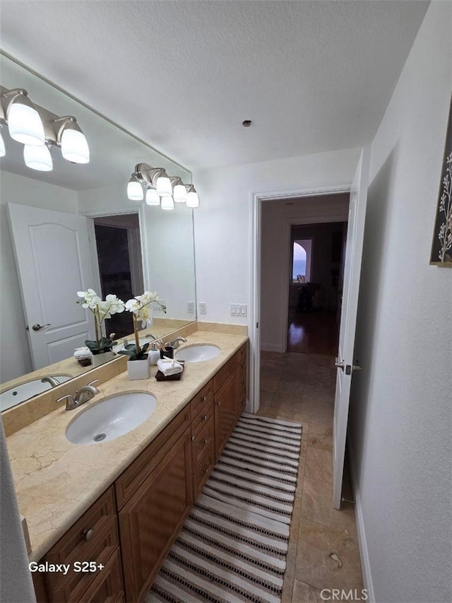 412 Arenoso Ln Unit 102, San Clemente, CA 92672 - full bath featuring double vanity, tile patterned flooring, and a textured ceiling