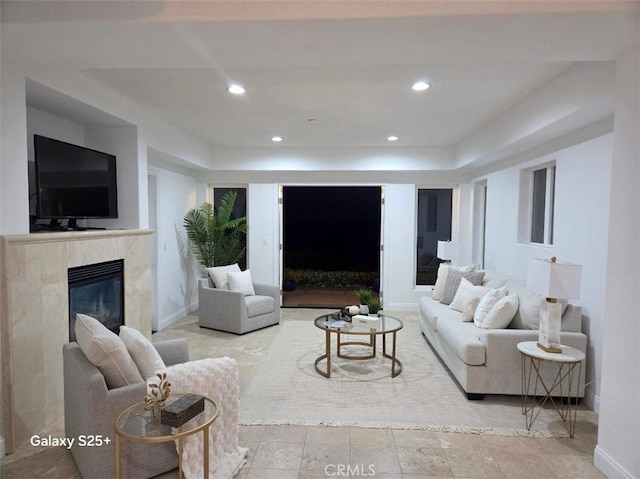 412 Arenoso Ln Unit 102, San Clemente, CA 92672 - living area featuring a premium fireplace, recessed lighting, a tray ceiling, and baseboards