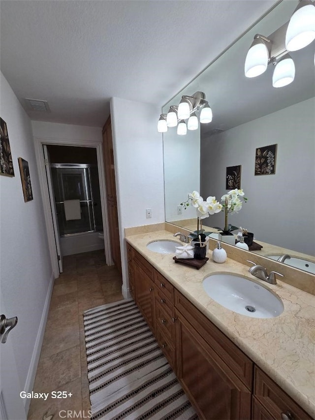 412 Arenoso Ln Unit 102, San Clemente, CA 92672 - full bath featuring tile patterned flooring, baseboards, double vanity, and a shower with door