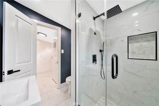 bathroom featuring a marble finish shower, baseboards, toilet, and marble finish floor
