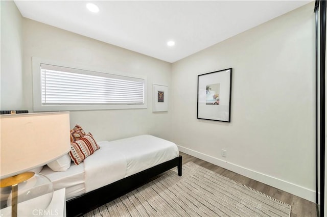 bedroom with recessed lighting, baseboards, and light wood finished floors