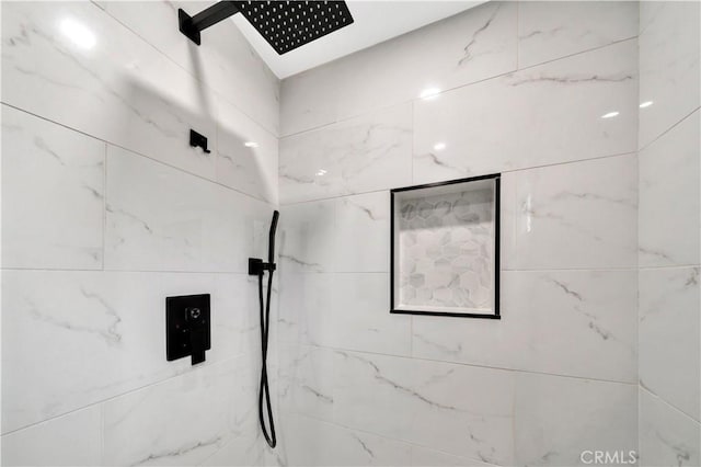 bathroom featuring a marble finish shower