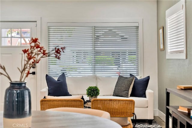 sitting room with plenty of natural light and wood finished floors