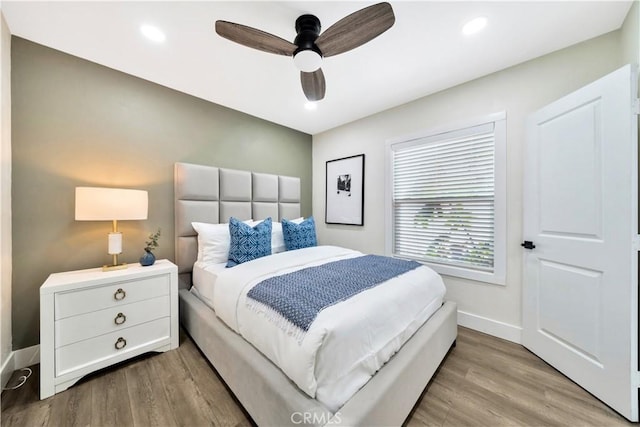 bedroom featuring baseboards, a ceiling fan, wood finished floors, and recessed lighting