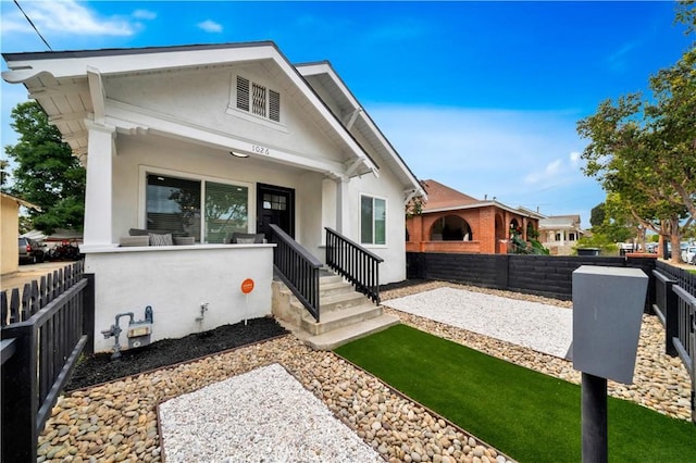 bungalow-style house featuring fence private yard and stucco siding