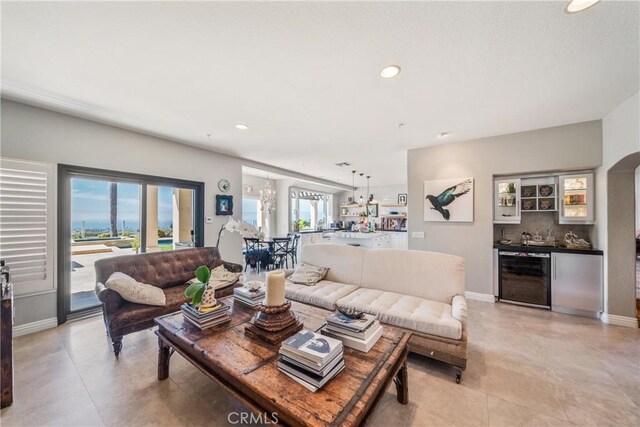 2009 Via Aguila, San Clemente, CA 92673 - living area featuring beverage cooler, healthy amount of natural light, bar, light tile patterned floors, and recessed lighting