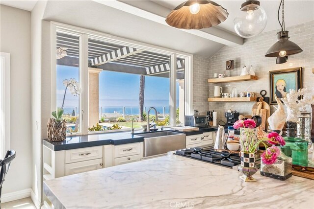 2009 Via Aguila, San Clemente, CA 92673 - kitchen featuring white cabinetry, dark stone countertops, pendant lighting, tasteful backsplash, and a water view