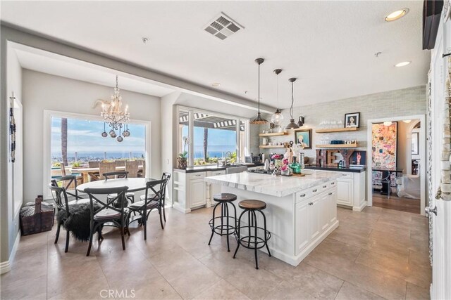 2009 Via Aguila, San Clemente, CA 92673 - kitchen featuring open shelves, a kitchen island, a chandelier, white cabinetry, and recessed lighting