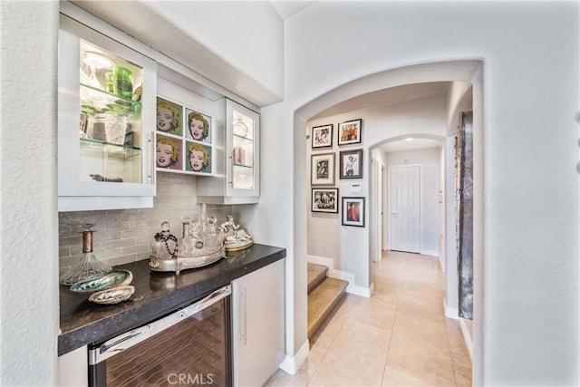 2009 Via Aguila, San Clemente, CA 92673 - hall featuring beverage cooler, arched walkways, light tile patterned floors, and stairway