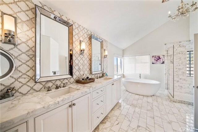 2009 Via Aguila, San Clemente, CA 92673 - full bath with lofted ceiling, plenty of natural light, a freestanding tub, double vanity, and a stall shower