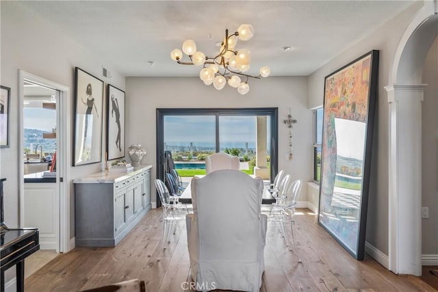 2009 Via Aguila, San Clemente, CA 92673 - dining area with a chandelier, light wood-style flooring, and arched walkways