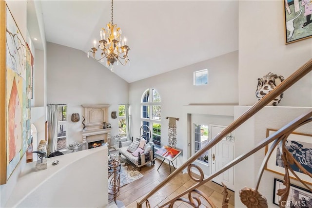 2009 Via Aguila, San Clemente, CA 92673 - foyer entrance with high vaulted ceiling, a lit fireplace, a chandelier, wood finished floors, and stairway