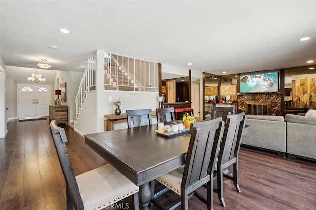 10313 Christine Pl, Chatsworth, CA 91311 - dining room with stairs, a chandelier, wood finished floors, a glass covered fireplace, and recessed lighting