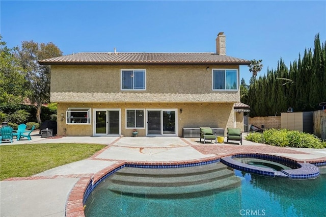 10313 Christine Pl, Chatsworth, CA 91311 - back of property featuring a patio area, a pool with connected hot tub, a chimney, and stucco siding