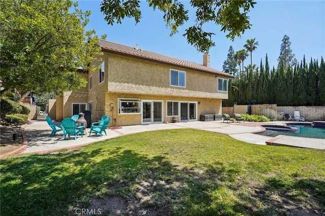 10313 Christine Pl, Chatsworth, CA 91311 - rear view of property featuring a patio, a chimney, stucco siding, and a pool with connected hot tub