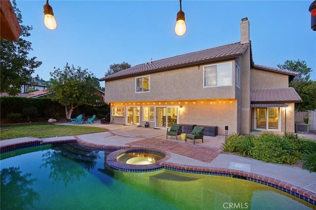 10313 Christine Pl, Chatsworth, CA 91311 - back of property with a chimney, stucco siding, a patio area, a pool with connected hot tub, and central air condition unit
