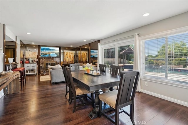 10313 Christine Pl, Chatsworth, CA 91311 - dining area featuring dark wood finished floors, a glass covered fireplace, baseboards, and recessed lighting