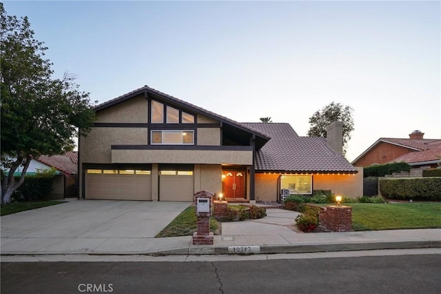 10313 Christine Pl, Chatsworth, CA 91311 - view of front of house with stucco siding, driveway, an attached garage, a chimney, and a tile roof