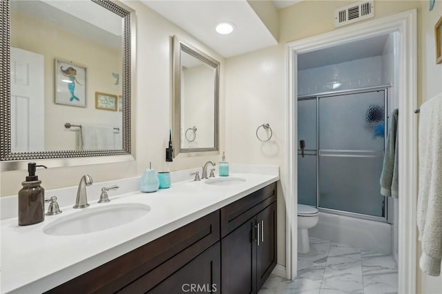 10313 Christine Pl, Chatsworth, CA 91311 - full bath featuring marble finish floors, toilet, double vanity, and combined bath / shower with glass door