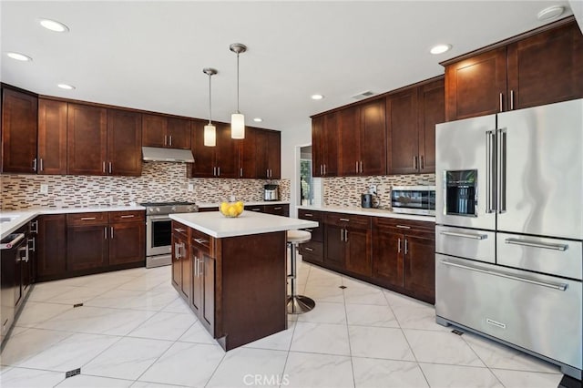 10313 Christine Pl, Chatsworth, CA 91311 - kitchen featuring premium appliances, light countertops, tasteful backsplash, a center island, and under cabinet range hood