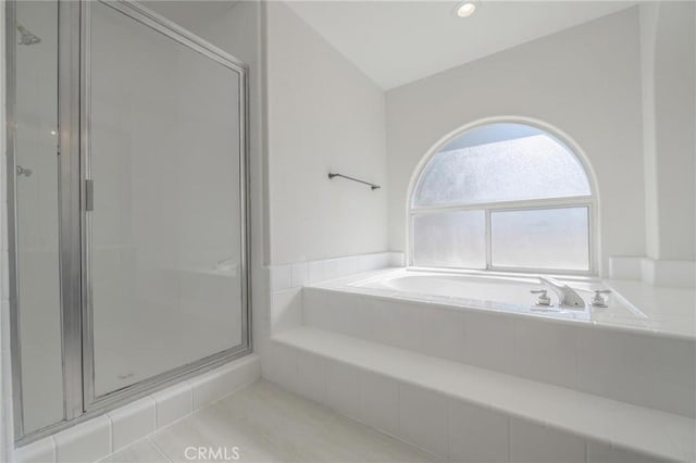 bathroom with a garden tub and a stall shower