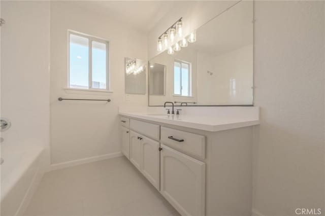 full bathroom featuring walk in shower, tile patterned flooring, a tub, vanity, and baseboards