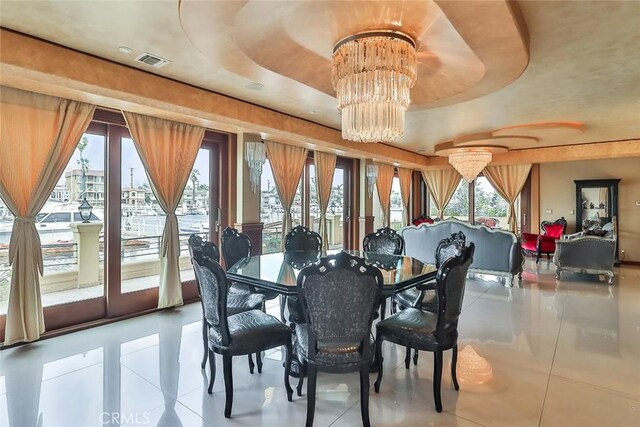5455 E Sorrento Dr, Long Beach, CA 90803 - dining area with tile patterned flooring, an inviting chandelier, a tray ceiling, and visible vents