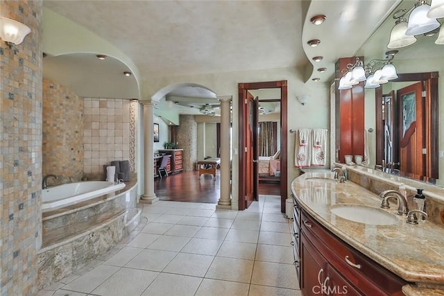 5455 E Sorrento Dr, Long Beach, CA 90803 - bathroom featuring a sink, a bath, tile patterned floors, double vanity, and ornate columns