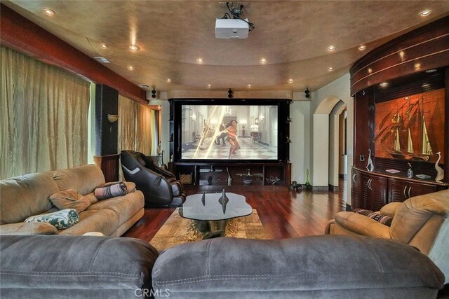 5455 E Sorrento Dr, Long Beach, CA 90803 - home theater featuring baseboards, recessed lighting, arched walkways, and wood finished floors