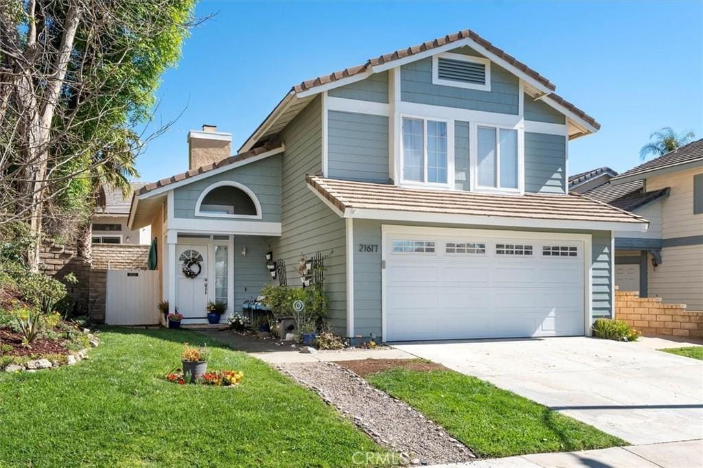 21617 Bedford Way, Saugus, CA 91350 - view of front of house featuring a chimney, a tile roof, driveway, and an attached garage