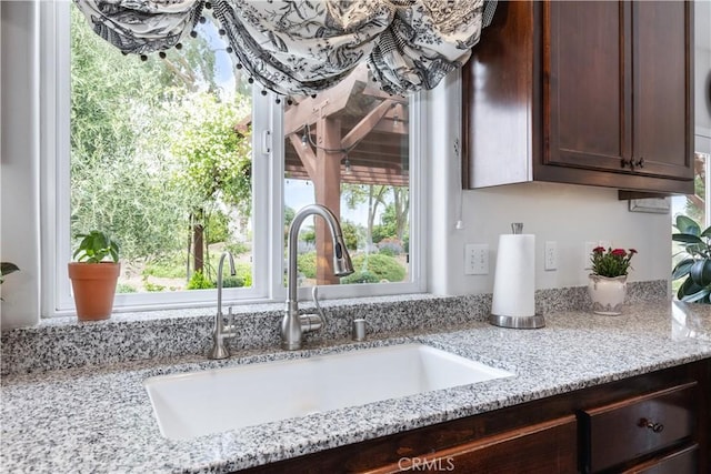 1835 Rancho Lomas Way, San Miguel, CA 93451 - kitchen view of a sink, dark brown cabinets, and light stone counters