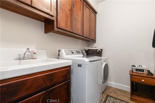 1835 Rancho Lomas Way, San Miguel, CA 93451 - laundry area with cabinet space, washer and clothes dryer, baseboards, and light tile patterned flooring