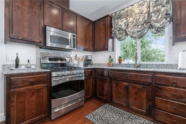 1835 Rancho Lomas Way, San Miguel, CA 93451 - kitchen featuring appliances with stainless steel finishes, a sink, dark wood finished floors, light stone counters, and dark brown cabinets