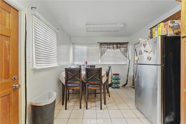 dining space featuring light tile patterned flooring