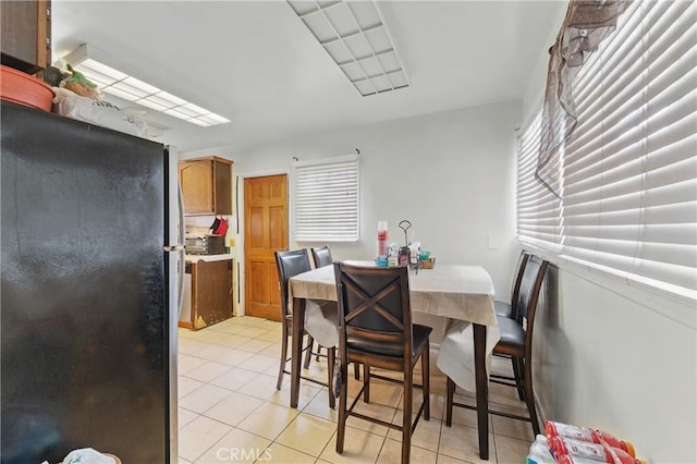 dining area with light tile patterned floors