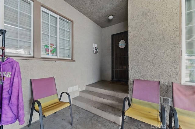 property entrance featuring stucco siding