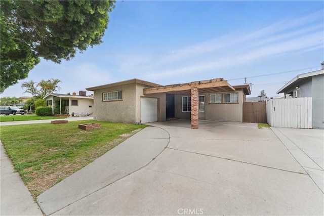 view of front of home with a garage, a front lawn, fence, a gate, and concrete driveway