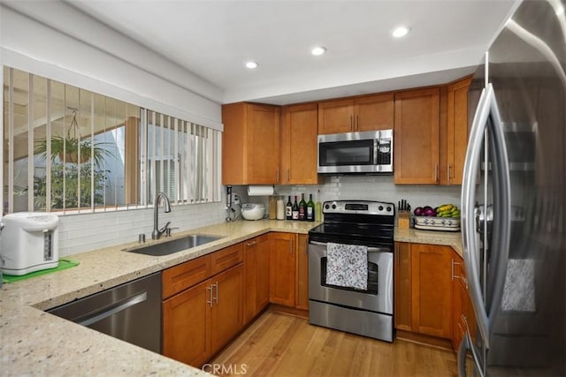 5472 Paseo Del Lago E Unit B, Laguna Woods, CA 92637 - kitchen with stainless steel appliances, a sink, brown cabinetry, and recessed lighting
