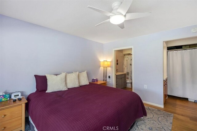 5472 Paseo Del Lago E Unit B, Laguna Woods, CA 92637 - bedroom featuring wood finished floors, ceiling fan, ensuite bath, and baseboards