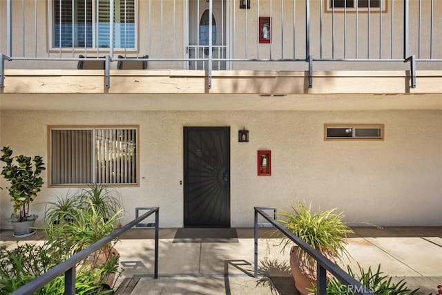 5472 Paseo Del Lago E Unit B, Laguna Woods, CA 92637 - view of exterior entry with a balcony and board and batten siding