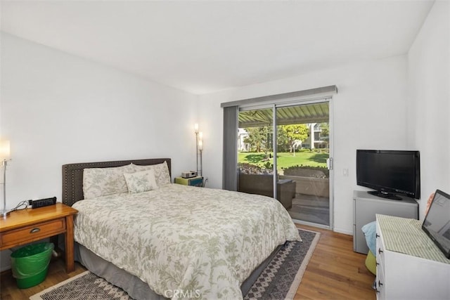 5472 Paseo Del Lago E Unit B, Laguna Woods, CA 92637 - bedroom featuring access to exterior and wood finished floors