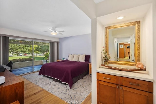 5472 Paseo Del Lago E Unit B, Laguna Woods, CA 92637 - bedroom with access to exterior, light wood finished floors, and ceiling fan