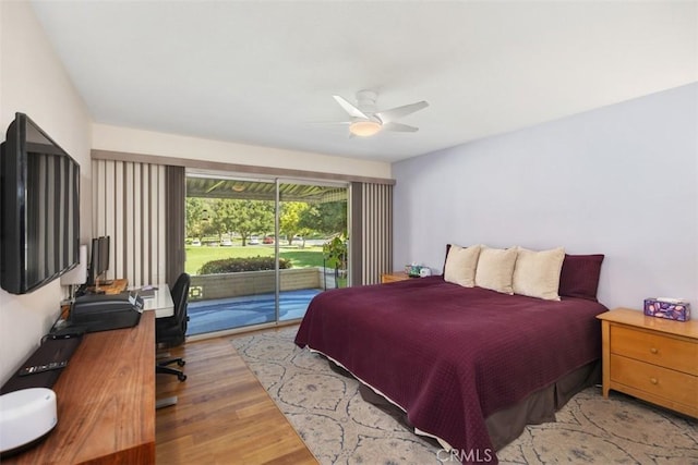 5472 Paseo Del Lago E Unit B, Laguna Woods, CA 92637 - bedroom with access to exterior, a desk, wood finished floors, and a ceiling fan