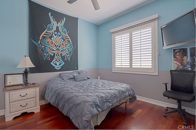 bedroom with a ceiling fan, wood finished floors, and baseboards