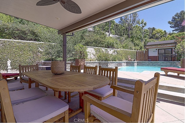 exterior space featuring a fenced in pool, outdoor dining area, ceiling fan, and fence