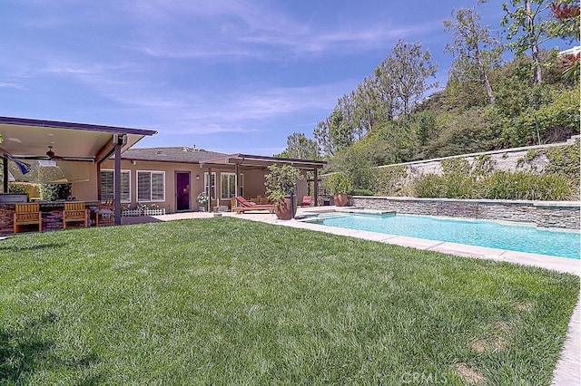 pool featuring a lawn, a patio, and ceiling fan