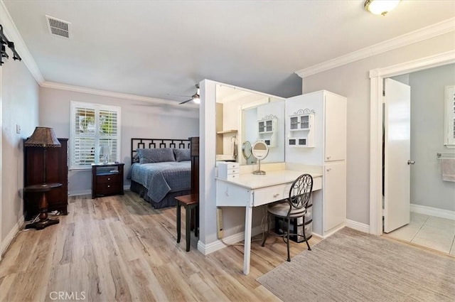 bedroom with ornamental molding, visible vents, and light wood-style floors